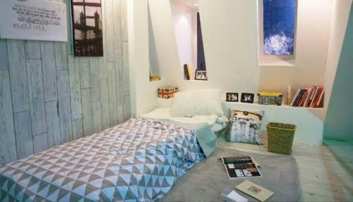 una camera con un letto nell'angolo di una stanza di ely guest house a Giacarta