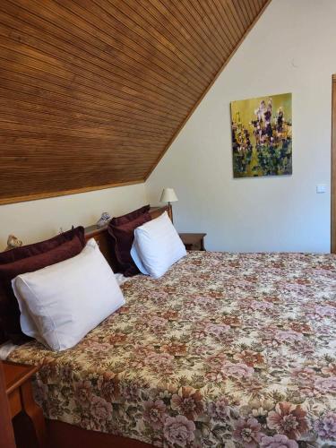 a bedroom with a bed with two pillows at Vila Florena Garden in Palanga