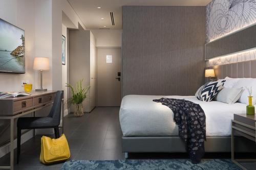 a hotel room with a bed and a desk and a desk at U Boutique Kinneret by the Sea of Galilee in Tiberias