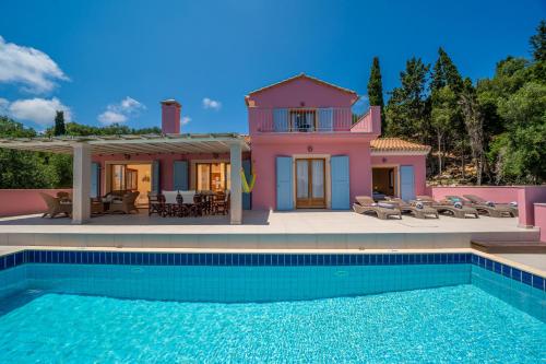 a house with a swimming pool in front of a house at Villa Helios Sea View & Private Pool near Fiskardo in Fiskardo