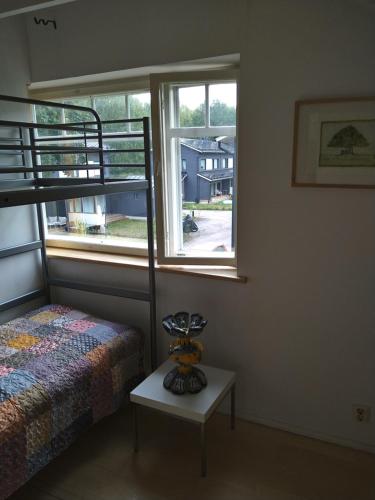 a bedroom with a bed and a window and a table at Helsinki Blue House in Helsinki
