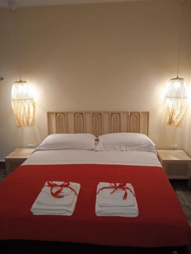 a bedroom with a bed with two towels on it at RAYO DE SOL in Marina di Casalvelino