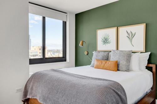 a bedroom with a large bed and a window at Tribeca Studio w Pool Roofdeck Gym View NYC-273 in New York