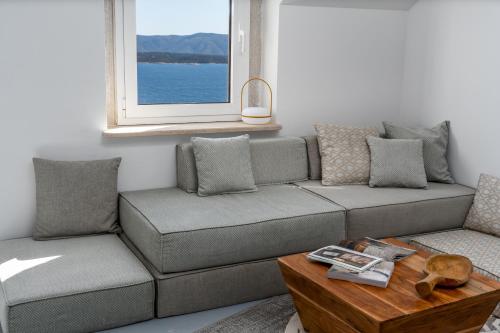 a living room with a couch and a table at Murvica resport in Murvica