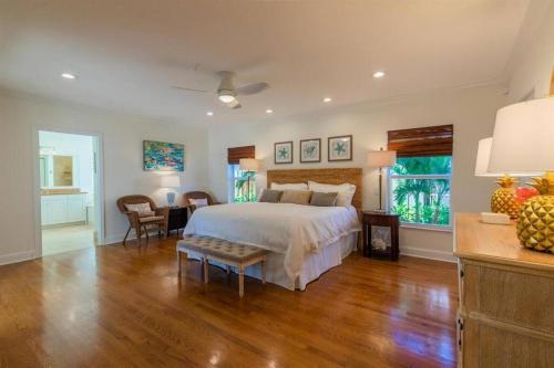 a bedroom with a bed and a table and a desk at Pineapple Palms Resort Style Pool Villa! Sleeps 12 in West Palm Beach
