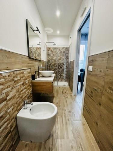 a bathroom with a tub and a sink and a mirror at Marea B&B in Milazzo