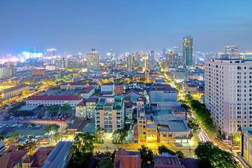 a cityscape of a city at night with buildings at Poulo Wai Hotel & Apartment in Phnom Penh