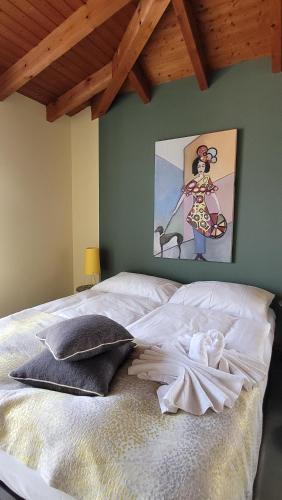 a bed in a bedroom with a painting on the wall at Hotel Rebstock in Luzern