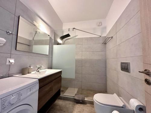 a bathroom with a sink and a washing machine at Dafni City Apartment 1 in Athens