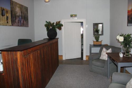 a living room with a wooden podium in a room at @karoo Guesthouse in Graaff-Reinet