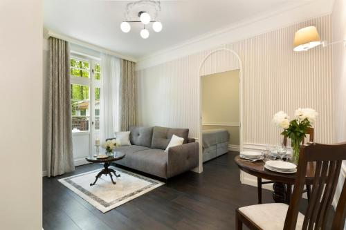 a living room with a couch and a table at Willa Szwarc by Elite Apartments in Sopot