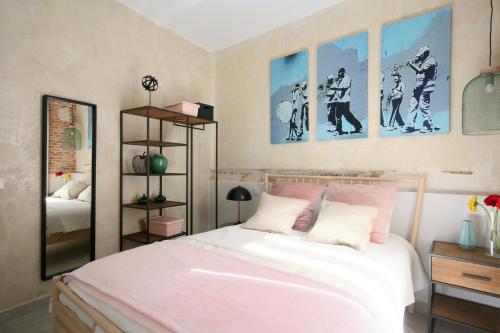 a bedroom with a white bed and some pictures on the wall at Charming Palacio Real in Madrid