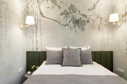 a bedroom with a bed with a painting on the wall at Willa Szwarc by Elite Apartments in Sopot