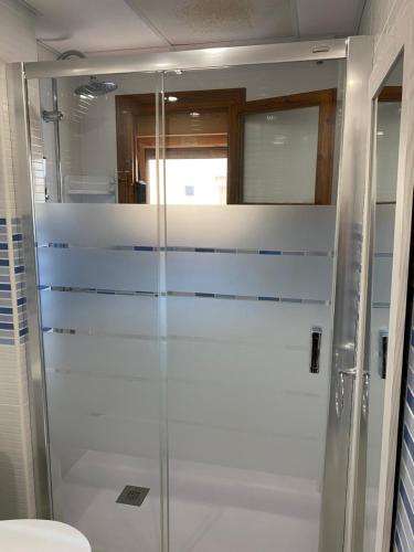 a glass shower in a bathroom with a toilet at La Mata beach apartment Viñamar I, 200m from the beach in La Mata