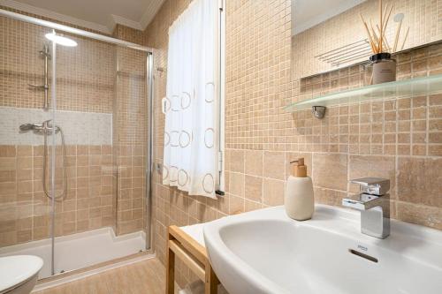 a bathroom with a sink and a shower at MyHouseSpain - Único piso cerca de la playa in Gijón