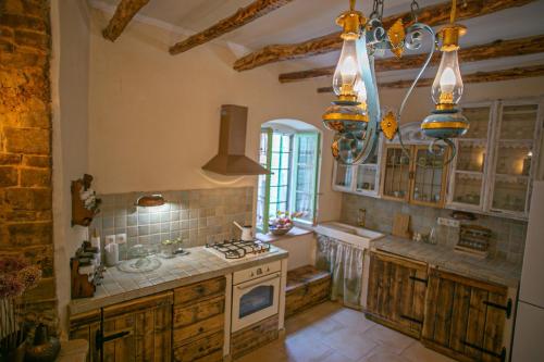 a large kitchen with wooden cabinets and a stove at Authentic house and traditional breakfast in Vrisnik