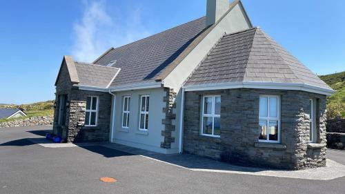 a brick house with a gray roof at The Cliffs of Moher House, Doolin in Doolin