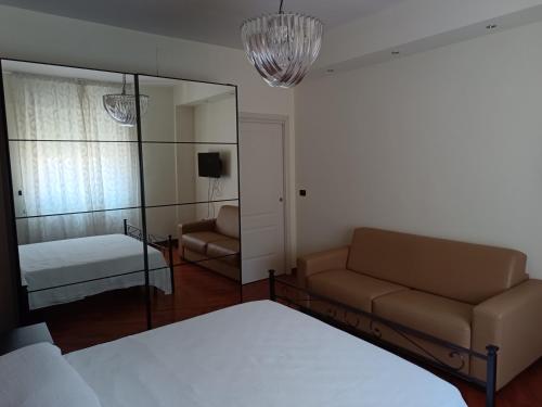 a living room with a couch and a mirror at Carola in Bari