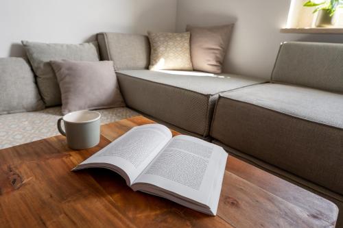 a coffee table with two books and a cup of coffee at Murvica resport in Murvica