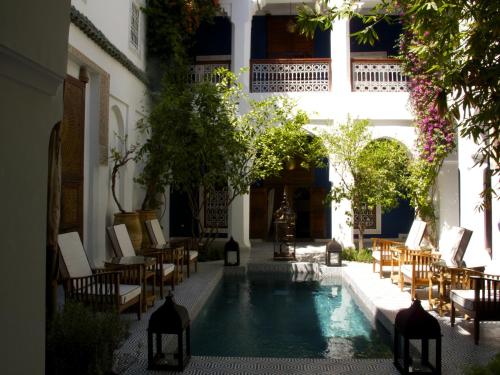 a courtyard with a swimming pool in a building at Riad Les Yeux Bleus in Marrakesh
