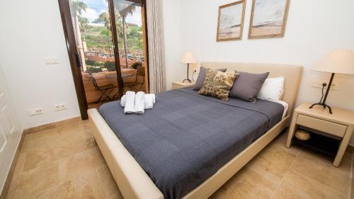 a bedroom with a bed with two pillows on it at Coto Real Thasos 222 in Manilva