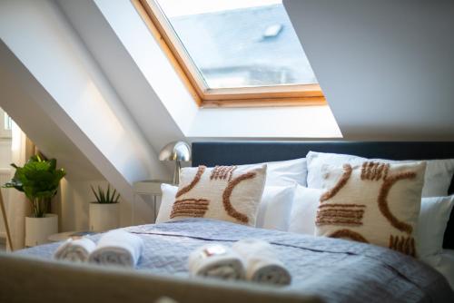 a bedroom with a bed with shoes on it at Arbio I Central Apartments Koblenz in Koblenz