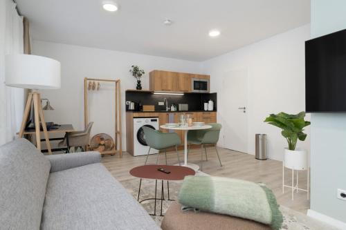 a living room with a couch and a table at Arbio I Central Apartments Koblenz in Koblenz