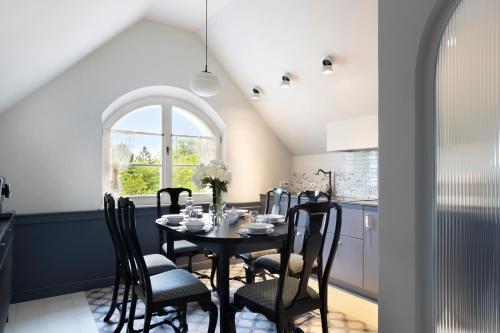 a dining room with a table and chairs at Willa Szwarc by Elite Apartments in Sopot