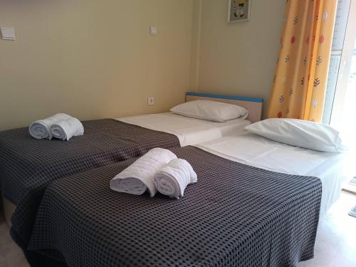 Duas camas com toalhas num quarto em 7 Seas House em Kalivia Poligirou