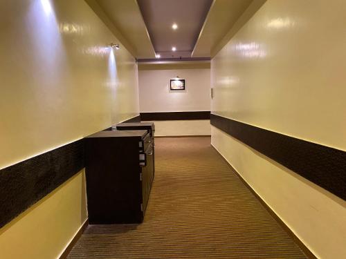 a long hallway with a waiting room with a tv at Hotel Pearl's BKC Inn- Near Trade Centre, Visa Consulate in Mumbai