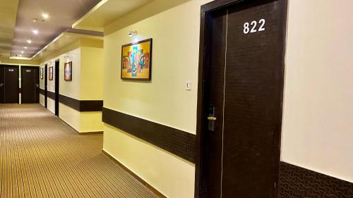 a hallway with a door with the on it at Hotel Pearl's BKC Inn- Near Trade Centre, Visa Consulate in Mumbai