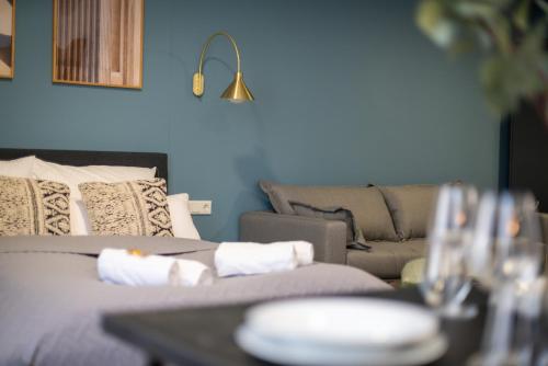 a living room with a couch and a table with wine glasses at Arbio I Central Apartments Koblenz in Koblenz