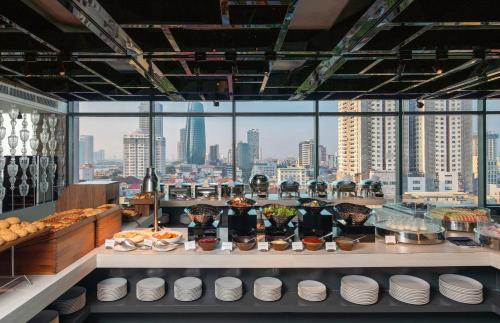 a buffet line with a view of a city at New Orient Hotel Da Nang in Da Nang