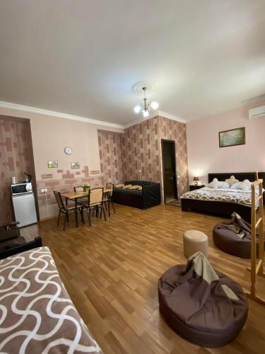 a large living room with a bed and a table at Guest house Lusia in Tbilisi City