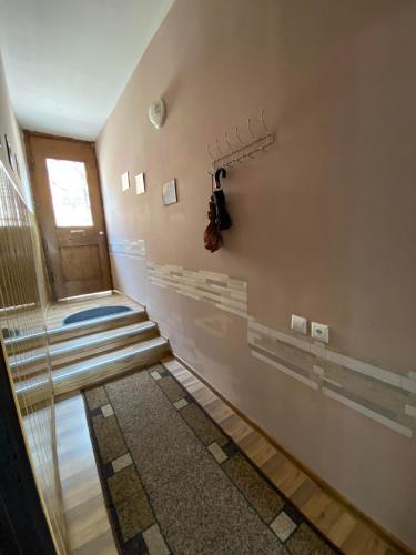 a hallway with stairs leading up to a door at Guest house Lusia in Tbilisi City