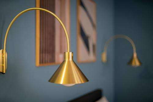 a close up of a brass lamp on a wall at Arbio I Central Apartments Koblenz in Koblenz