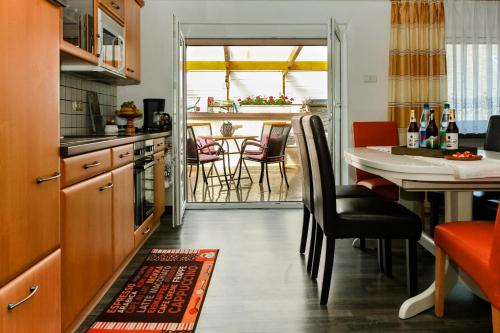 a kitchen with a table and a dining room at Ferienwohnung am Sachsenring 