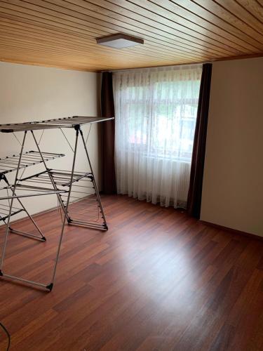 a room with a table and a window and a wooden floor at esa house in Kireçhane