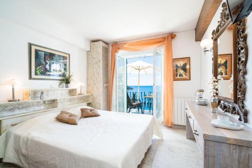 a bedroom with a bed and a view of the ocean at Beach House Sveti Jakov 1 in Dubrovnik