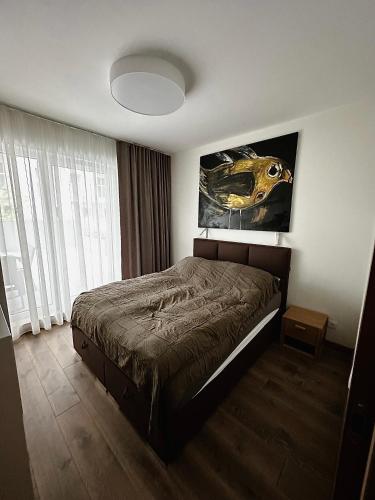 a bedroom with a bed and a large window at Apartament VIP Wola in Warsaw