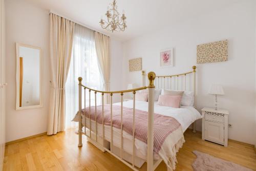 a bedroom with a bed and a chandelier at Pfamhaus Penthouse in St. Wolfgang