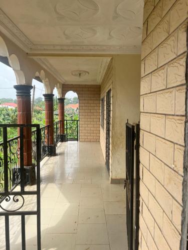 an empty corridor of a building with a balcony at A&G Guest House Kumba in Kumba