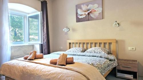 a bedroom with a bed with two pillows on it at Authentic Vacation Flat Near Beach in Kotor in Kotor