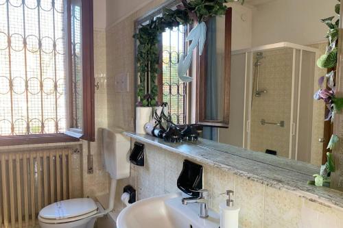 a bathroom with a sink and a toilet and a mirror at Venezia Canal View in Venice