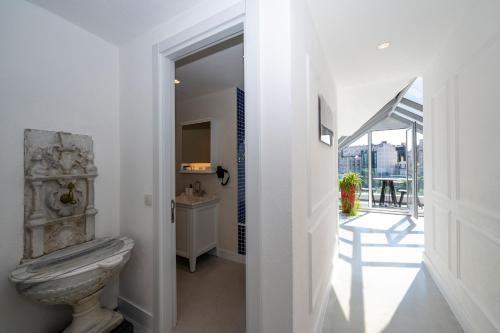 a white bathroom with a toilet and a balcony at Juno Hotel Taksim in Istanbul