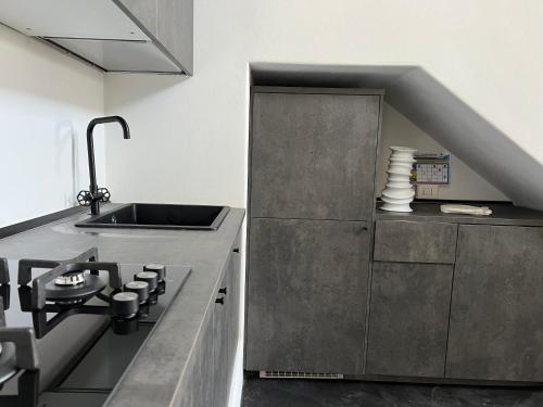a kitchen with a sink and a stainless steel counter at Casa Due Lune in Stromboli