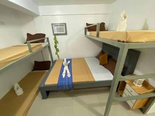 a small room with two bunk beds in it at Prim Travellers Inn in Coron