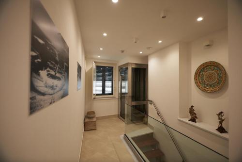 a staircase in a house with a glass railing at Corvaja Inn in Taormina