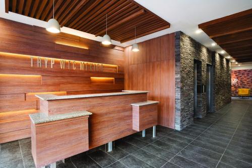 a bar in a restaurant with wooden walls at TRYP by Wyndham Mexico City World Trade Center Area in Mexico City