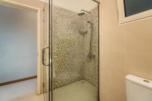 a shower with a glass door in a bathroom at The Ridge Residence in Victoria